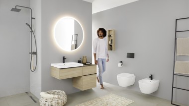 Man walks into the bathroom with washbasin, WC, bidet and bathroom furniture from the Geberit iCon bathroom series Man walks into the bathroom with washbasin, WC, bidet and bathroom furniture from the Geberit iCon bathroom series